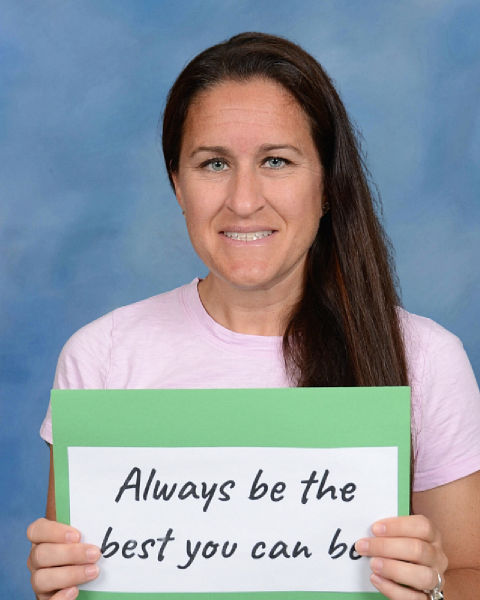 Ms. Hise holding a sign saying Be the Best You Can Be